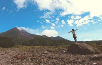 woman looking at sky and mountain image